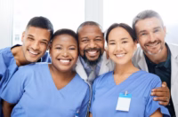 Smiling healthcare workers and doctors standing together.