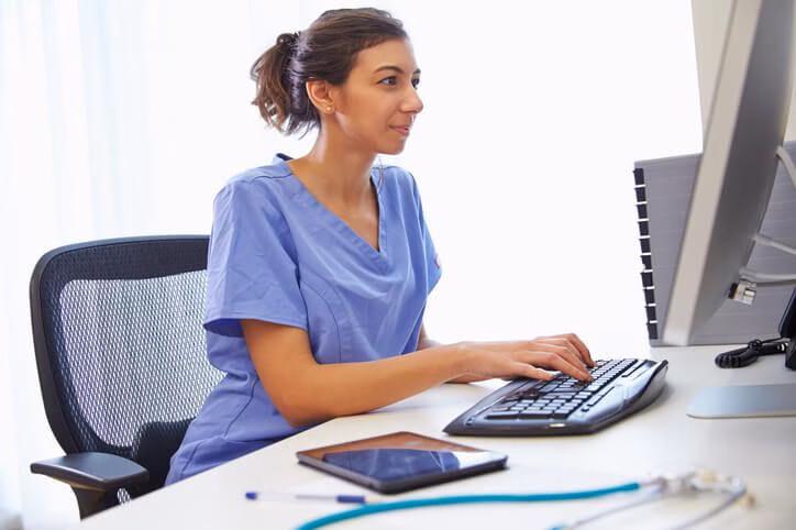 A smiling female medical office specialist after medical office specialist training.