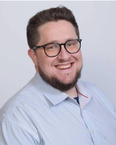 Headshot of Edward Rabinovich the CEO of Manhattan School of Computer Technology wearing a button up shift and glasses